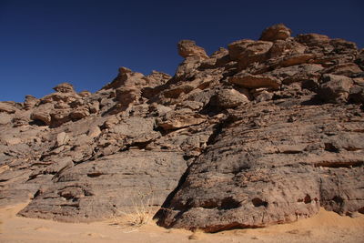 Low angle view of rock formation against clear sky acacus mountain,libya