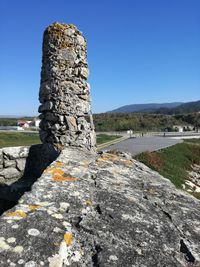 View of rock on landscape against clear sky