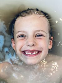 Portrait of smiling girl in bathtub