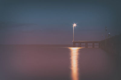 Scenic view of sea against clear sky at night