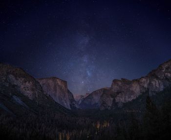 Scenic view of mountains against sky at night