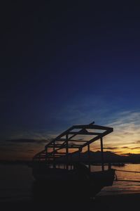 Pier on sea at sunset