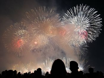 Low angle view of firework display at night