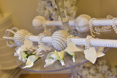 Close-up of white roses hanging on plant