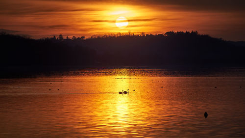 Scenic view of sea against orange sky