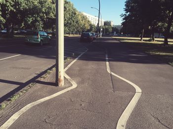 Road by street in city against sky