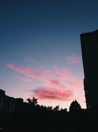 Low angle view of silhouette trees against sky at sunset