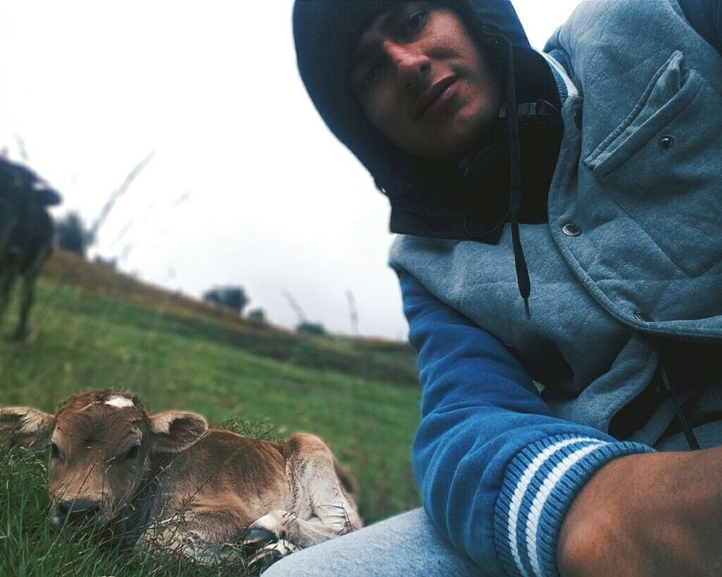 REAR VIEW OF MAN ON GRASS