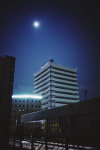 Low angle view of modern building against blue sky