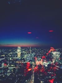 High angle view of illuminated city buildings at night