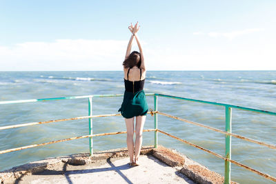 Young girl in dress enjoying a vacation near the summer sea of italy