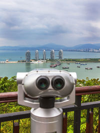 Binoculars for viewing the panorama of the city. sanya phoenix island president resort apartment