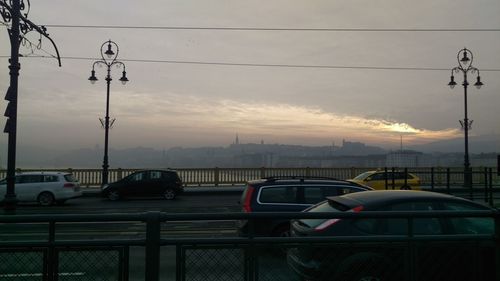 Cars on road at sunset