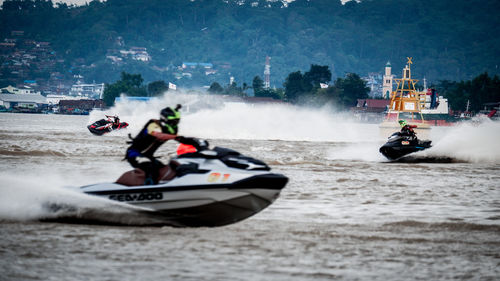 People riding motorcycle on sea