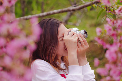 Woman photographing at park