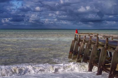 Scenic view of sea against cloudy sky