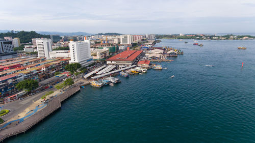 High angle view of buildings by sea against sky