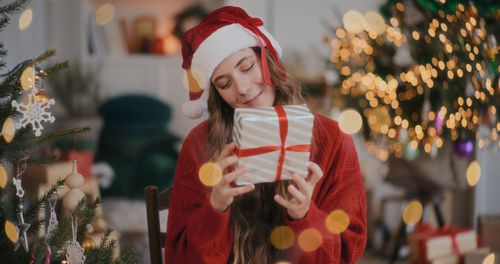 Portrait of young woman holding gift