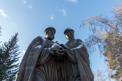 Monument to saints peter and fevronia, the patrons of marriage and family against the blue sky.