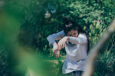 Woman dancing in forest