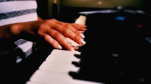 Midsection of woman playing piano