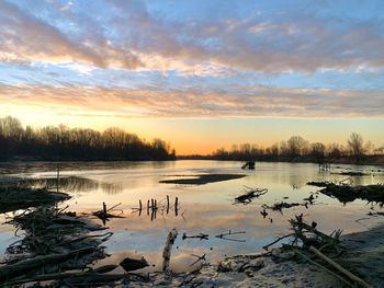 Scenic view of lake against sky during sunset