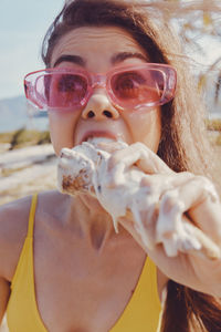 Portrait of young woman drinking water