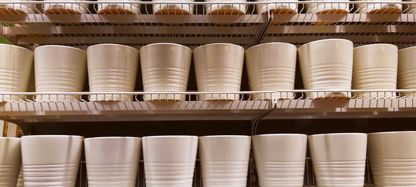 Close-up of ceramic glasses on shelf