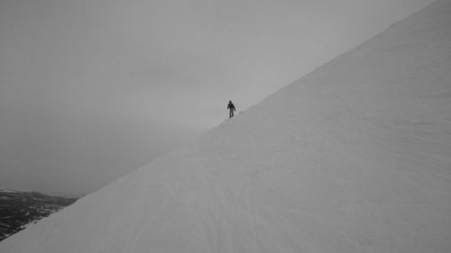 Man on snow covered mountain during winter