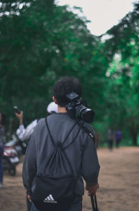 Rear view of man photographing