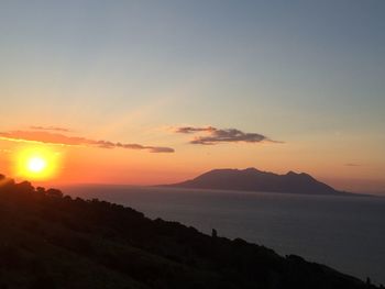 Scenic view of silhouette mountains against sky during sunset