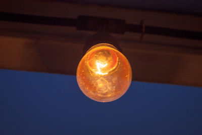 Close-up of lit light bulb