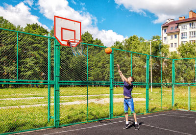 Young man playing basketball in court