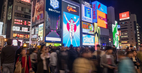 People walking on street in city at night