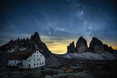 Scenic view of snowcapped mountains against sky at night