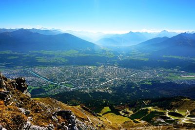 High angle view of land and mountains against sky