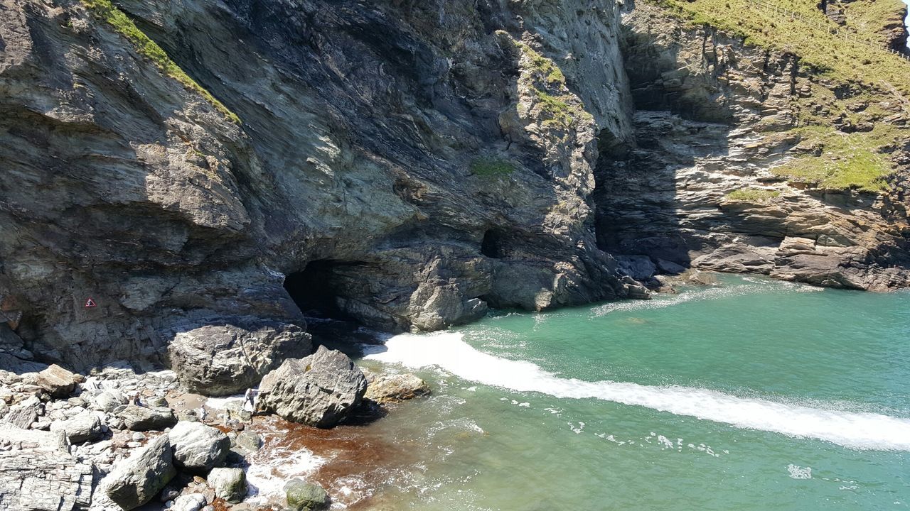 water, rock - object, nature, rock formation, beauty in nature, tranquility, rock, tranquil scene, scenics, sea, day, river, outdoors, high angle view, no people, sunlight, beach, stone - object, idyllic, tree