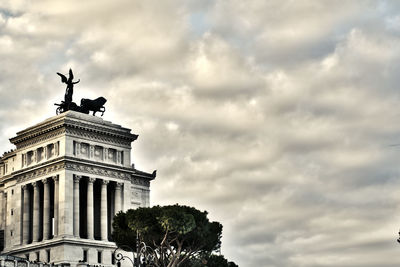 Low angle view of statue against cloudy sky