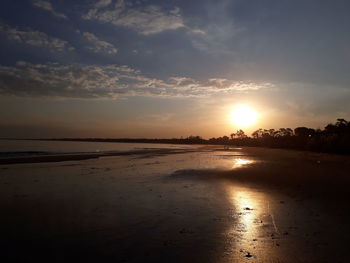 Scenic view of beach against sky during sunset