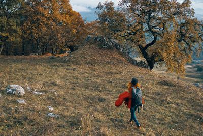 Woman walking on field during autumn