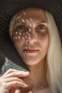 Close-up portrait of woman wearing hat