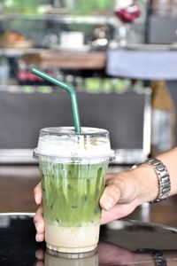 Cropped image of hand holding drink