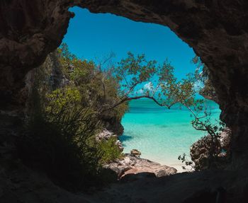 Scenic view of sea seen through cave