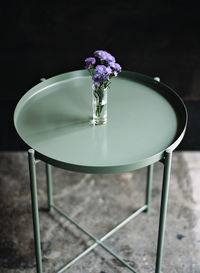 Purple flower vase on green  table