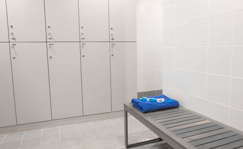 Close-up of blue box on tiled floor against wall at home