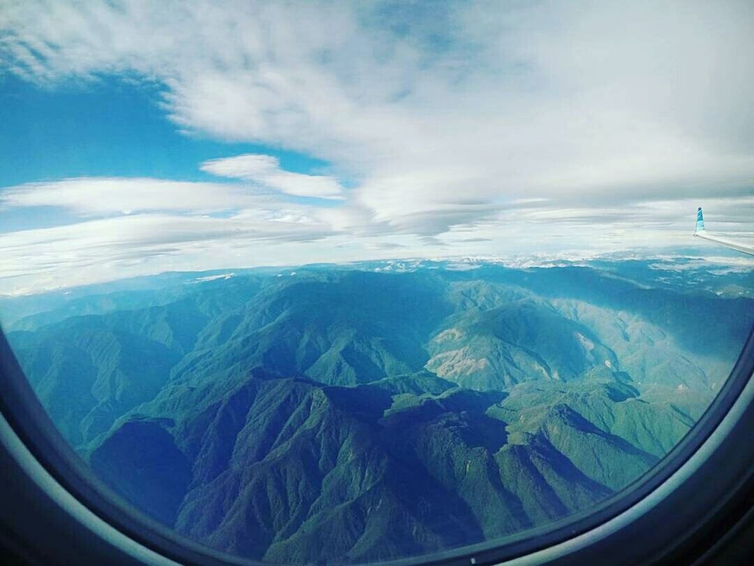 AERIAL VIEW OF LANDSCAPE AND AIRPLANE WINDOW