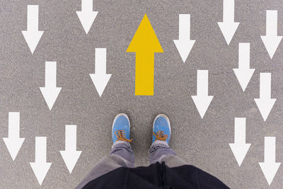 Low section of man standing on road