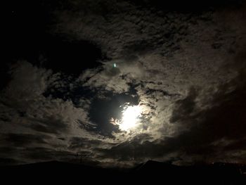 Low angle view of silhouette moon against sky at night