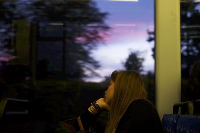 Woman looking through train window