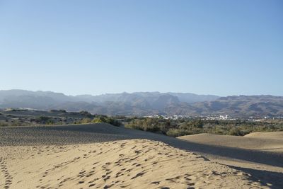 Scenic view of mountains against clear blue sky